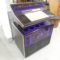 A Rock-Ola R453 Jukebox with vinyl records, circa 1970s. Working order. Key present. Comes with a