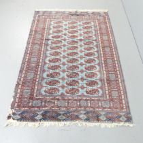 A red-ground Afghan rug. 188x125cm. Some moth damage. Sold as seen.