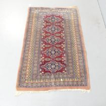 A red-ground Persian rug. 133x82cm.