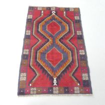 A red-ground Baluchi rug. 135x84cm.