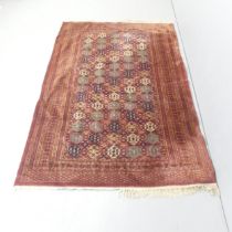 A red-ground Bokhara rug. 193x126cm.