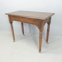 A Victorian oak hall table, with turned legs and brass casters. 100x77x48cm.