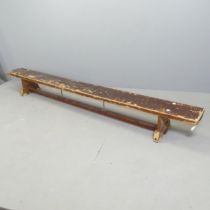 A vintage stained pine school gymnasium bench. 267x29x25cm