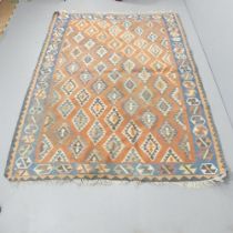 A red-ground Kilim carpet. 240x175cm Some loss to fringes, some holes. Please see additional