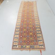 A red-ground Afghan runner. 270x68cm.