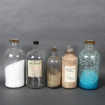 A selection of large antique glass apothecary bottles, some with contents and associated labels,