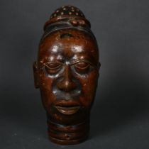 An early 20th century Nigerian terracotta head, height 22cm.