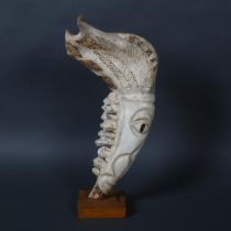 A lower horse jaw bone scrimshaw engraving on wooden stand, height 32.5cm.