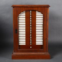 A Victorian mahogany microscope slide collectors cabinet, with recessed brass handle and glass door