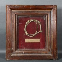 "The cable from an electric fire, used by George Bernard Shaw", housed in a Victorian stained wood