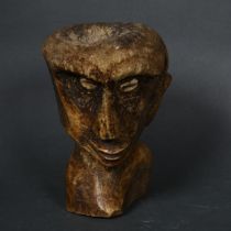 A South Seas carved bone bust, with shell eyes, height 17cm.