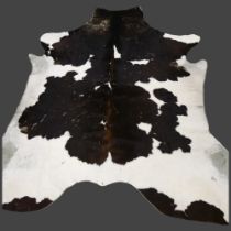 Taxidermy - a Large Black and White Cow Skin Hide Rug, approximately 190cm x 150cm.