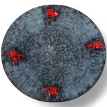 A mid century Brutalist wall hanging plate, with matt blue glaze and red accents, unsigned, diameter