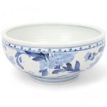 JONATHAN CHISWELL JONES, a studio pottery porcelain bowl with blue and white floral painted glaze,
