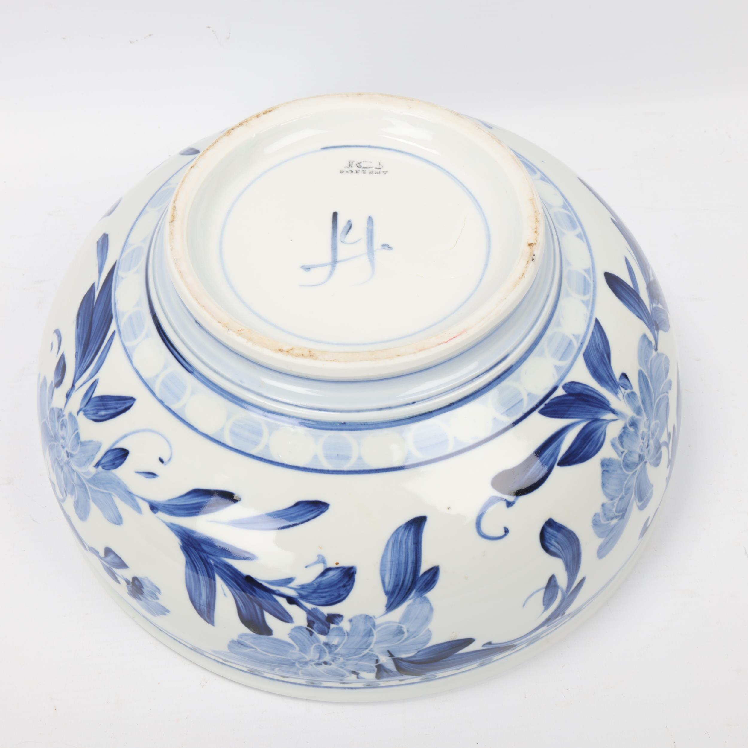 JONATHAN CHISWELL JONES, a studio pottery porcelain bowl with blue and white floral painted glaze, - Image 2 of 3