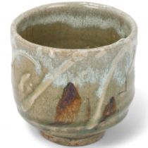 TAKESHI YASUDA (born 1943); a stoneware yunomi , with ash and chun glaze and raised slip decoration,