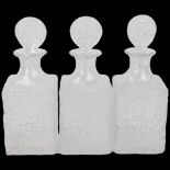 Three Whitefriars Glacier pattern clear glass (flint colourway) whisky decanters, with matching
