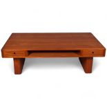 A mid 20th century teak coffee table by Trioh, Denmark, with two double sided sliding drawers and