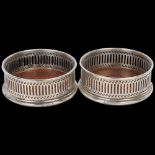 A pair of Elizabeth II silver-mounted oak wine bottle coasters, MC Hersey & Son Ltd, London 1982,