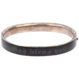 A Victorian French silver and black enamel 'God bless you' hinged mourning bangle, band width 9.2mm,