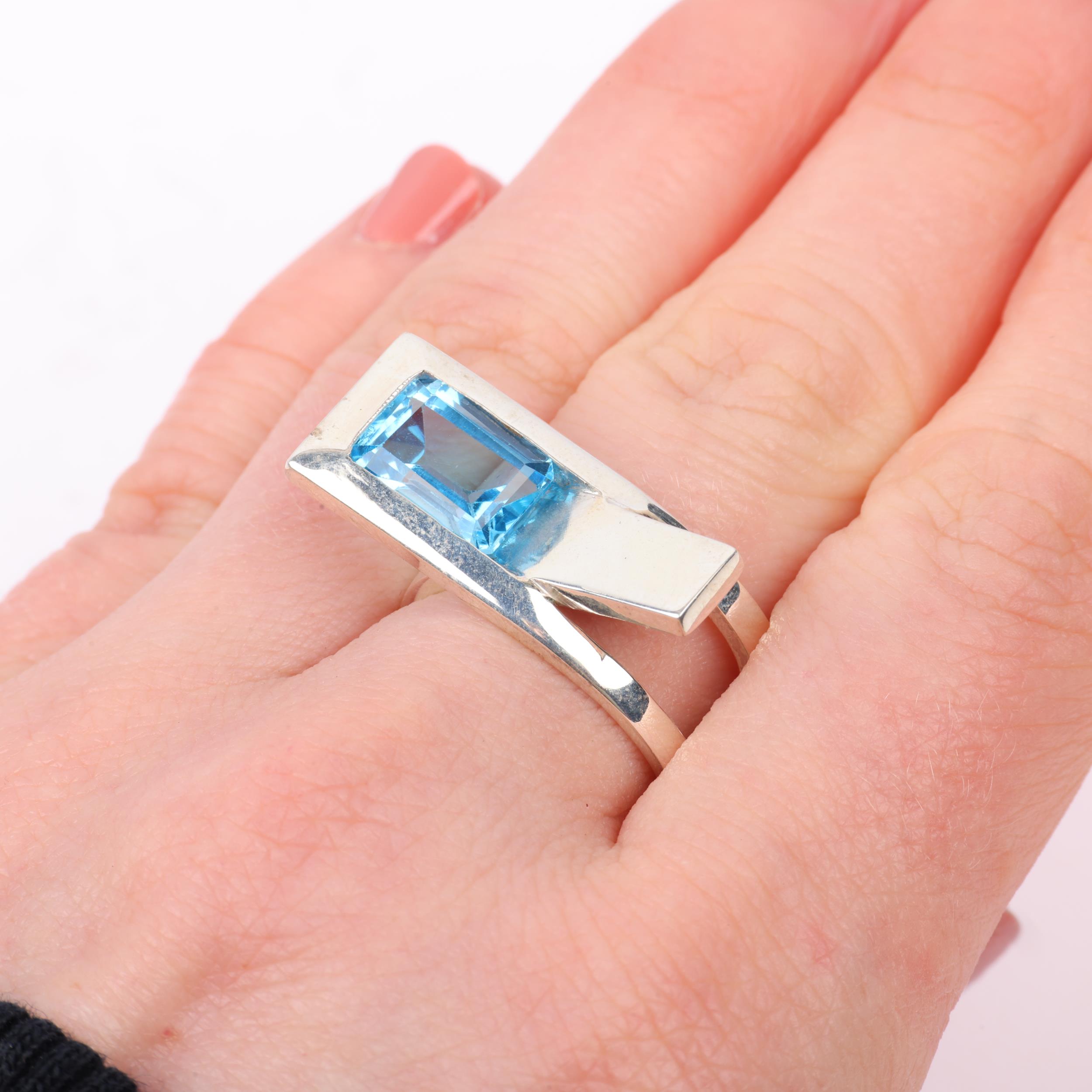 A modern sterling silver blue topaz crossover ring, London 2023, band width 11.4mm, size P, 13g - Image 3 of 3