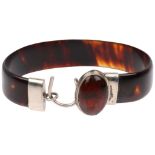 An early 20th century tortoiseshell and amber torque bangle, band width 12.8mm, internal