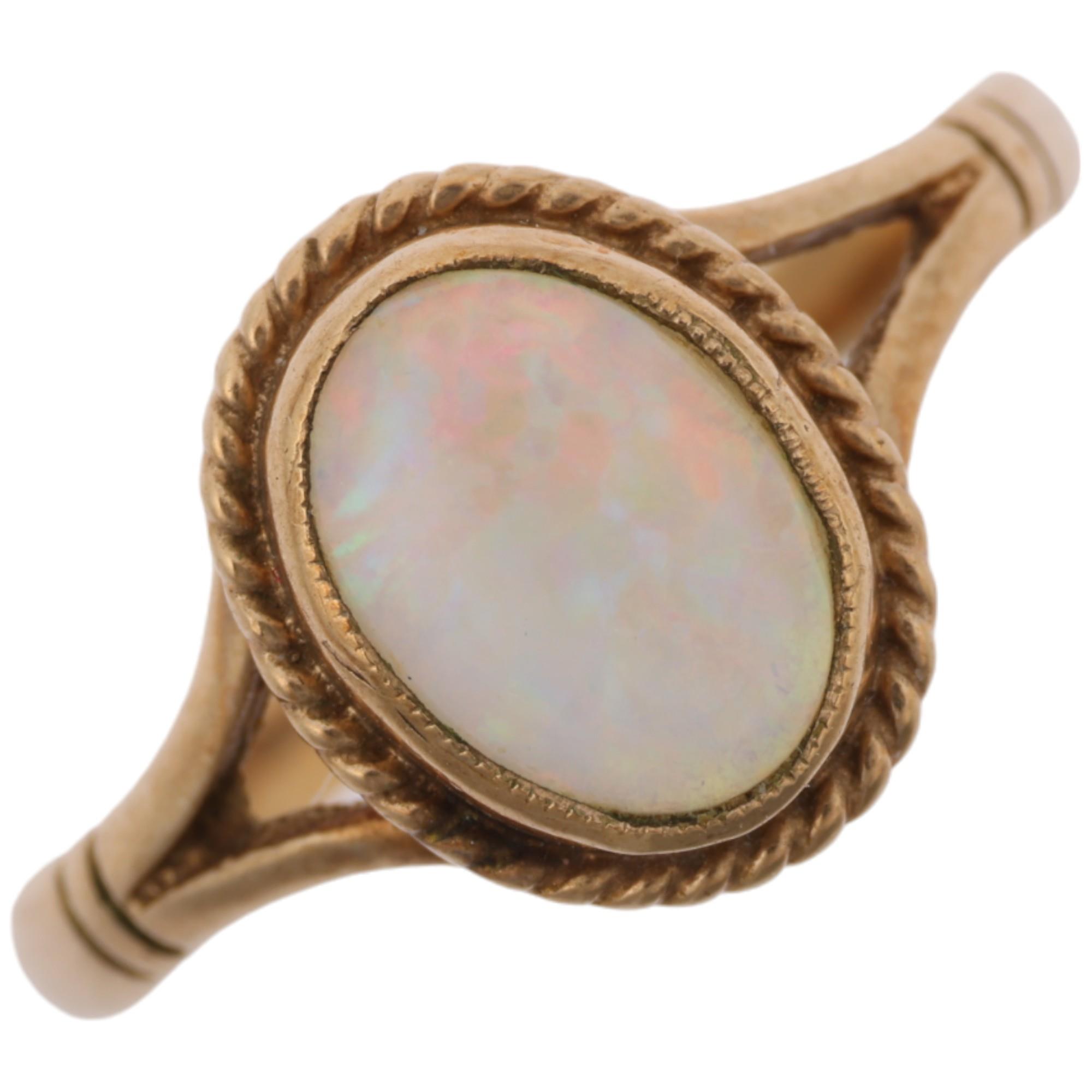 A late 20th century 9ct gold opal dress ring, maker S&S, Birmingham 1995, rub-over set with oval
