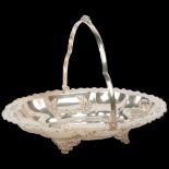 An Edwardian silver swing-handled cake basket, A Willis & Co, Sheffield 1904, oval lobed form with