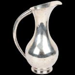 A large Japanese silver ewer, circa 1940, signed on base, baluster form with large tapered handle