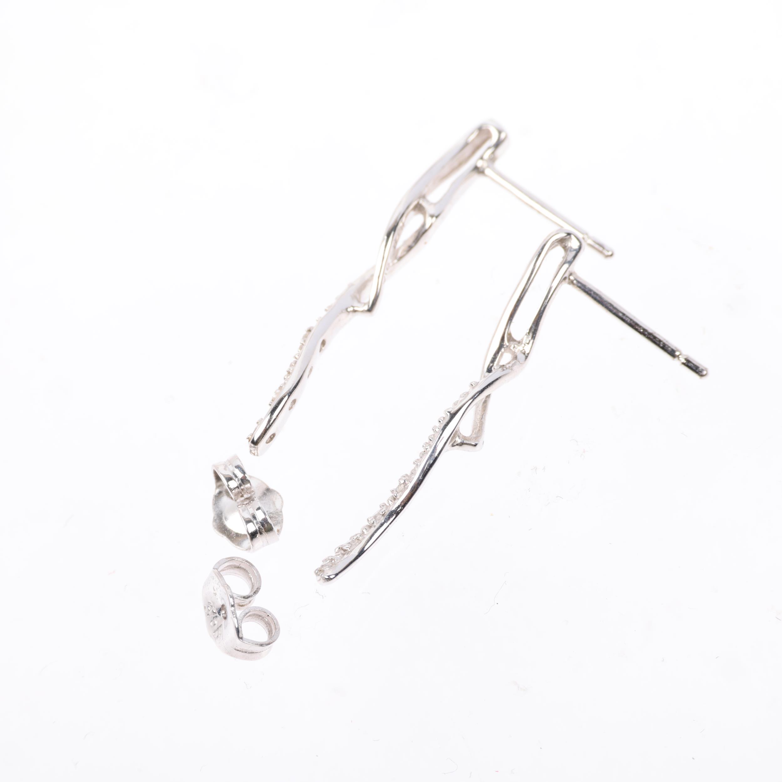 A pair of 9ct white gold diamond ribbon earrings, with stud fittings, set with eight-cut diamonds, - Image 3 of 4