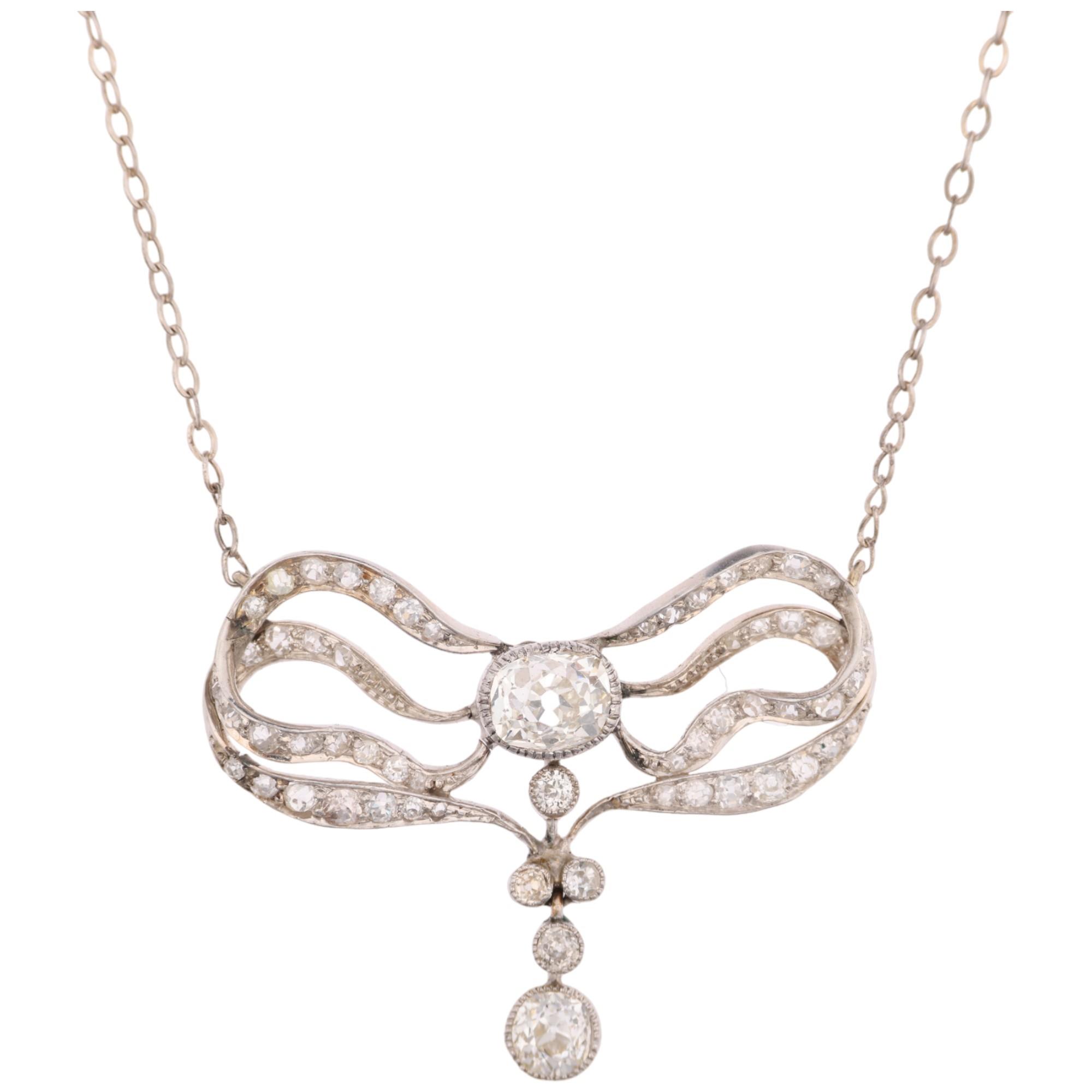 An Art Nouveau French diamond ribbon bow pendant necklace, circa 1910, set with old and eight-cut