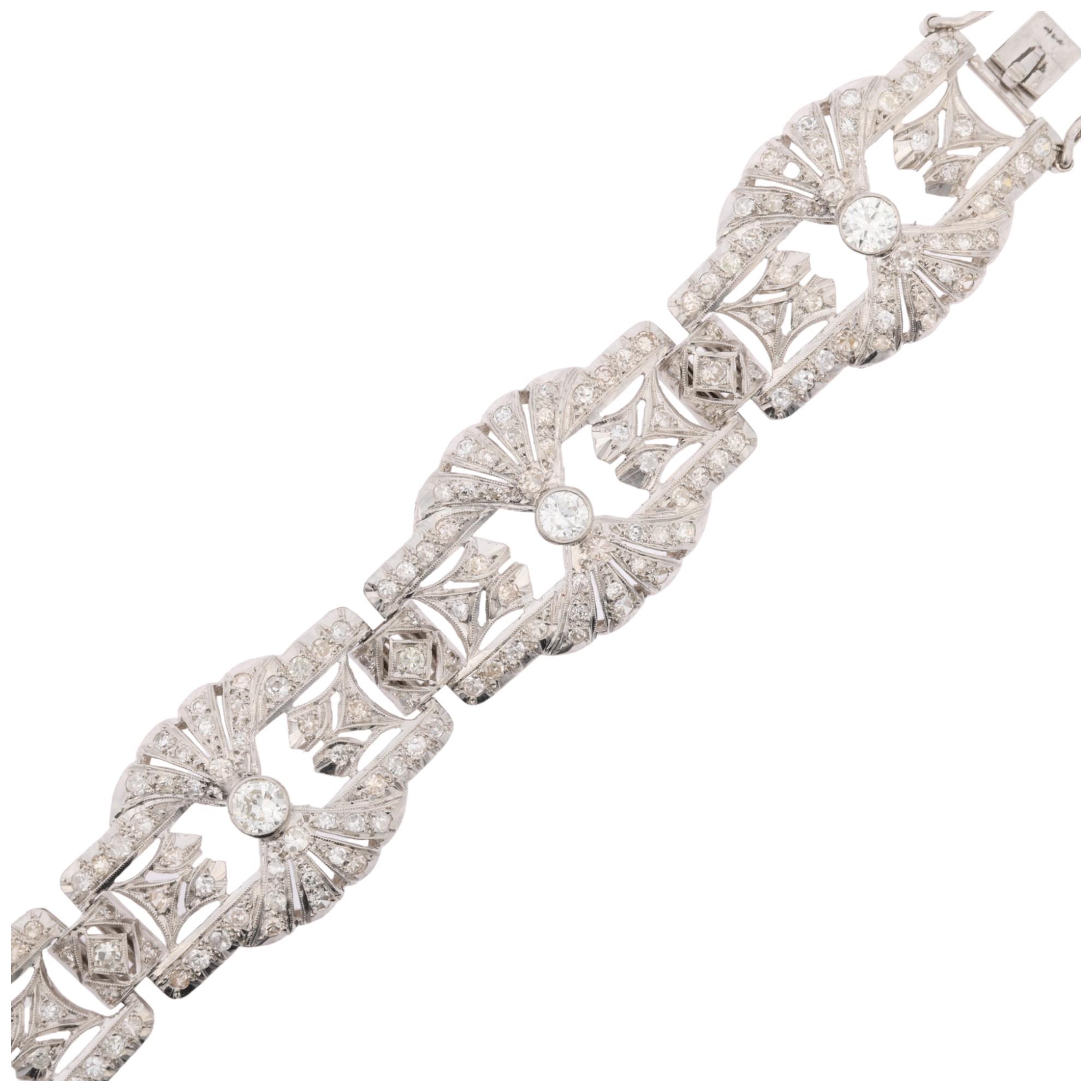 An Art Deco platinum and diamond panel bracelet, the 6 panels having openwork fan decoration and