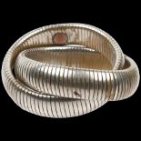 ATTRIBUTED TO BUTLER & WILSON - a Vintage expanding double twist bangle, internal circumference