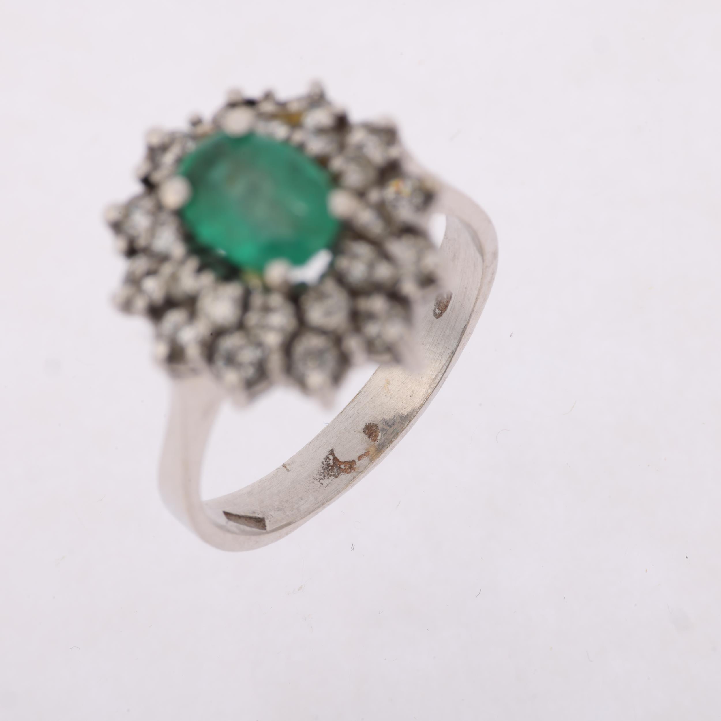 A Continental 18ct white gold emerald and diamond flowerhead cluster ring, claw set with oval - Image 3 of 4