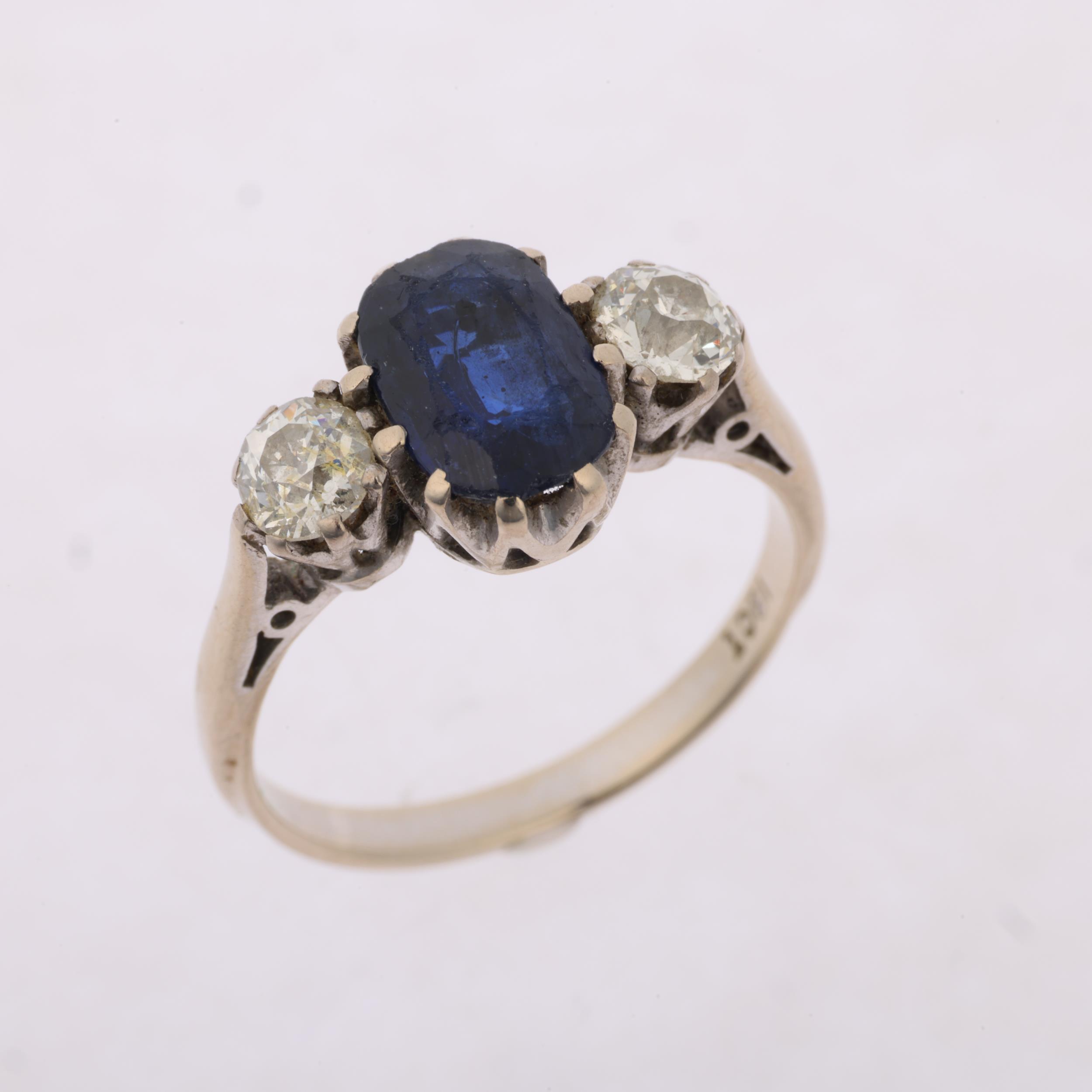 An 18ct white gold three stone sapphire and diamond ring, claw set with 1.7ct oval mixed-cut - Image 2 of 4