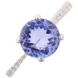An 18ct white gold tanzanite and diamond dress ring, claw set with round-cut tanzanite and modern