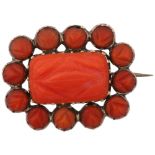 A Georgian coral cluster mourning brooch, circa 1820, cut-down collet set with carved coral within