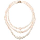 A Vintage triple-strand graduated 'Angel Skin' coral bead necklace, with 9ct gold clasp, coral beads