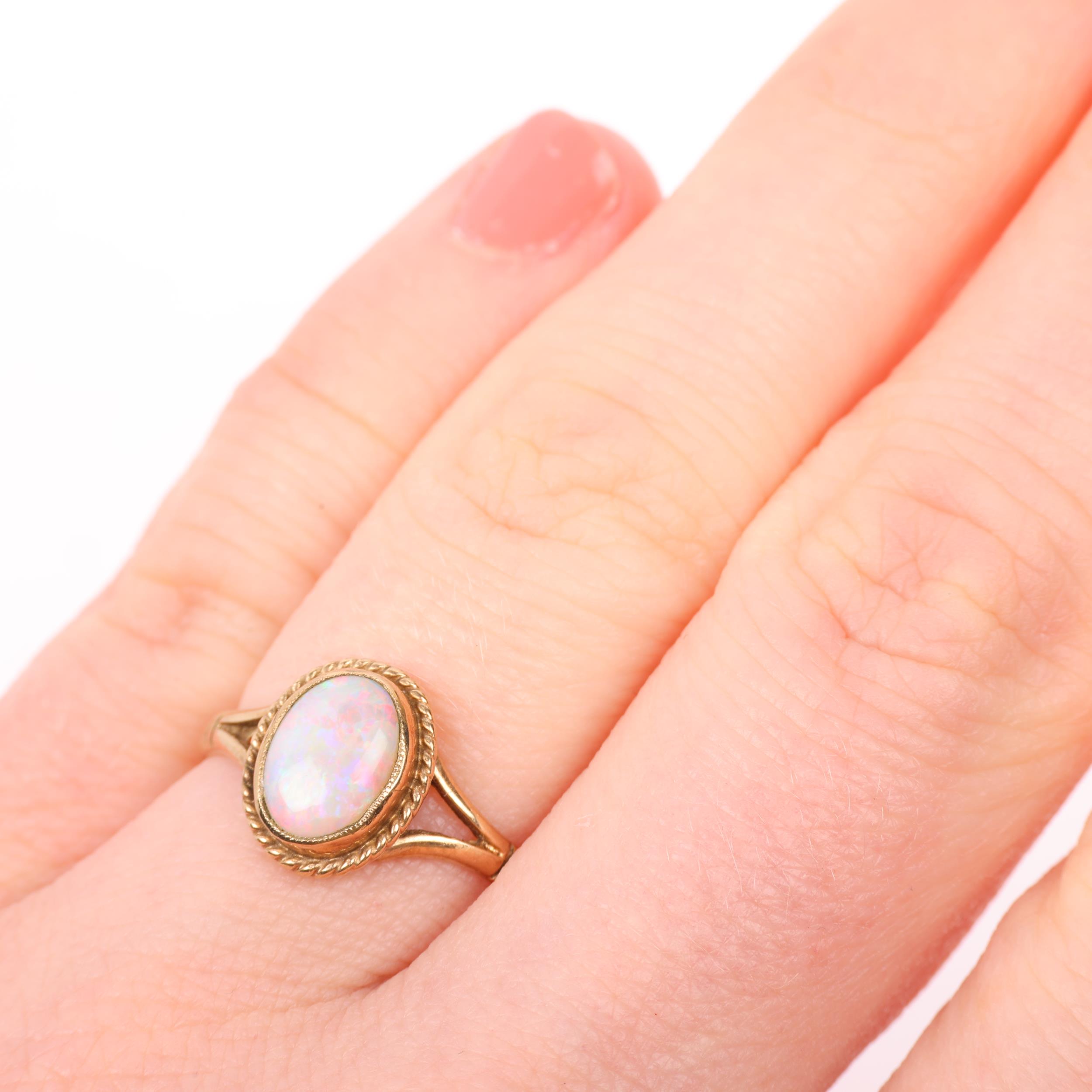 A late 20th century 9ct gold opal dress ring, maker S&S, Birmingham 1995, rub-over set with oval - Image 4 of 4