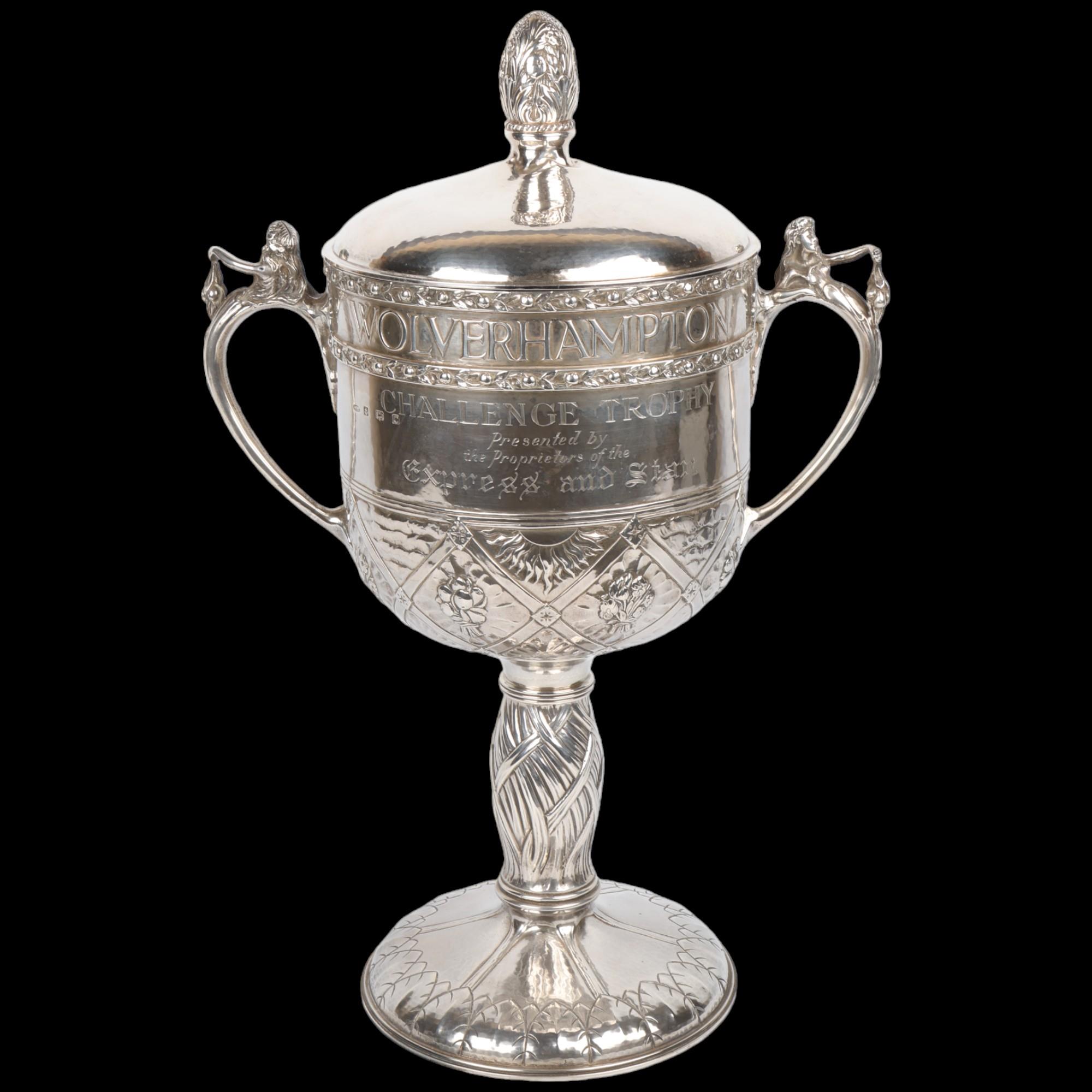 An impressive and unique Arts and Crafts George V silver 2-handled presentation trophy cup and