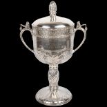 An impressive and unique Arts and Crafts George V silver 2-handled presentation trophy cup and