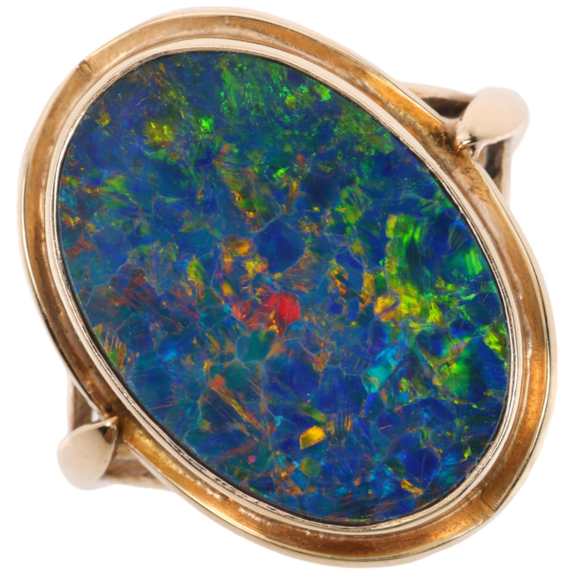 A late 20th century black opal doublet dress ring, apparently unmarked Continental gold settings,