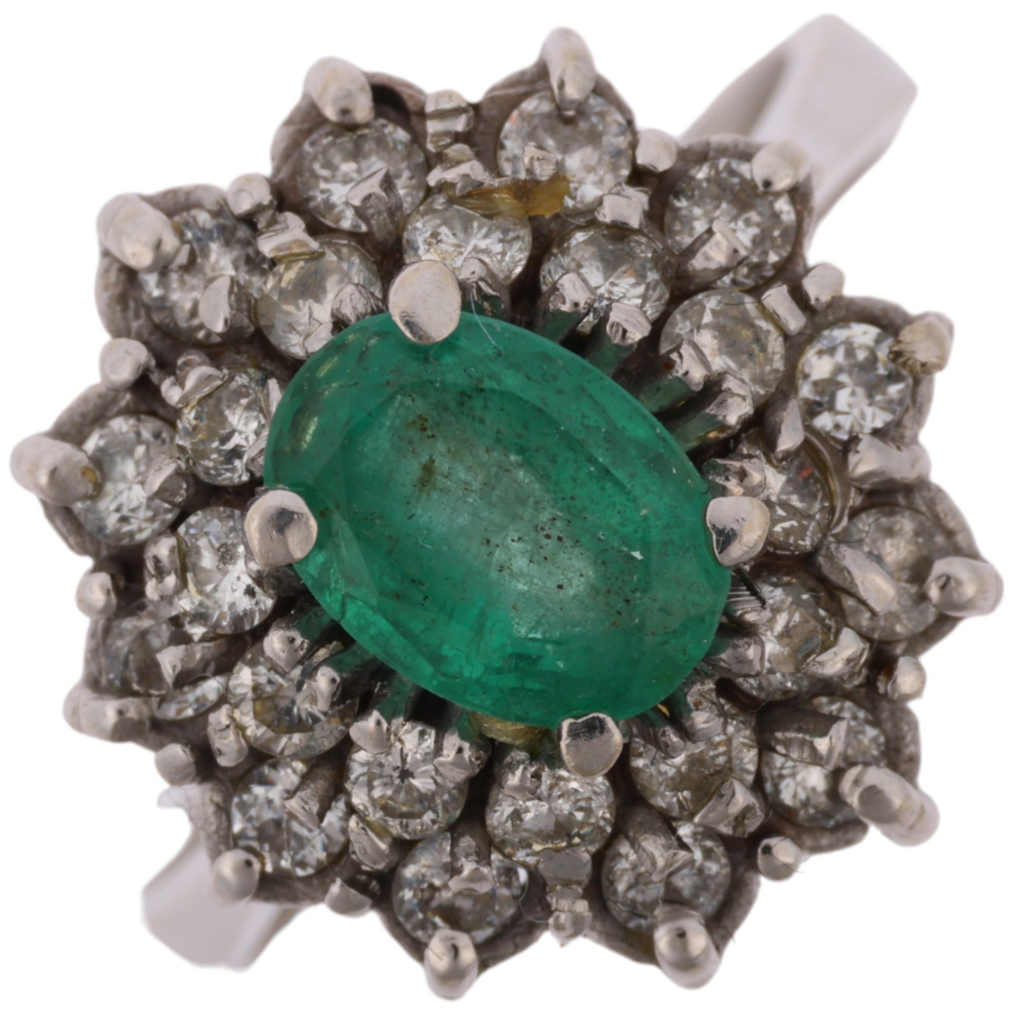 A Continental 18ct white gold emerald and diamond flowerhead cluster ring, claw set with oval