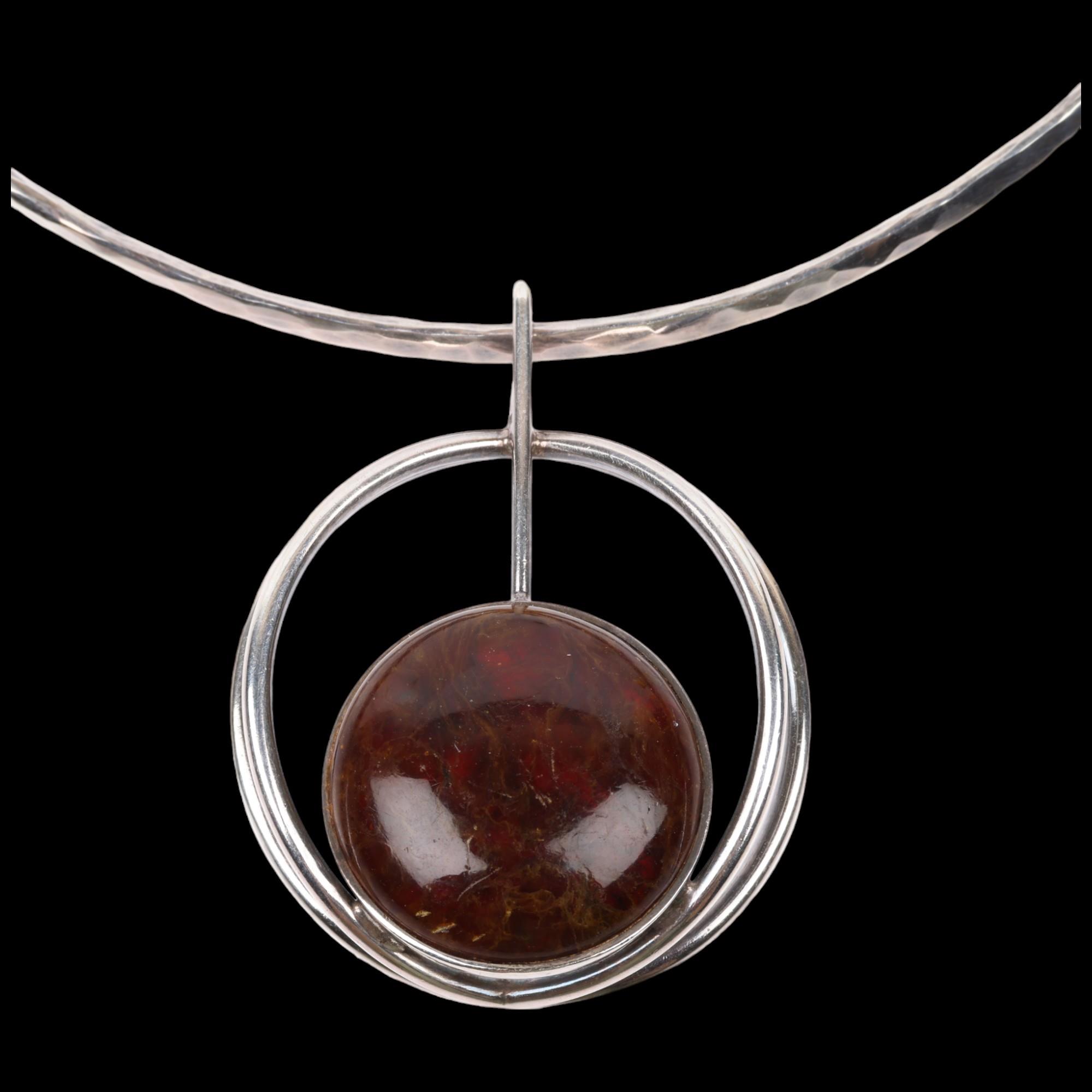 CARL OVE FRYDENSBERG - a a Danish modernist sterling silver amber openwork pendant necklace, on