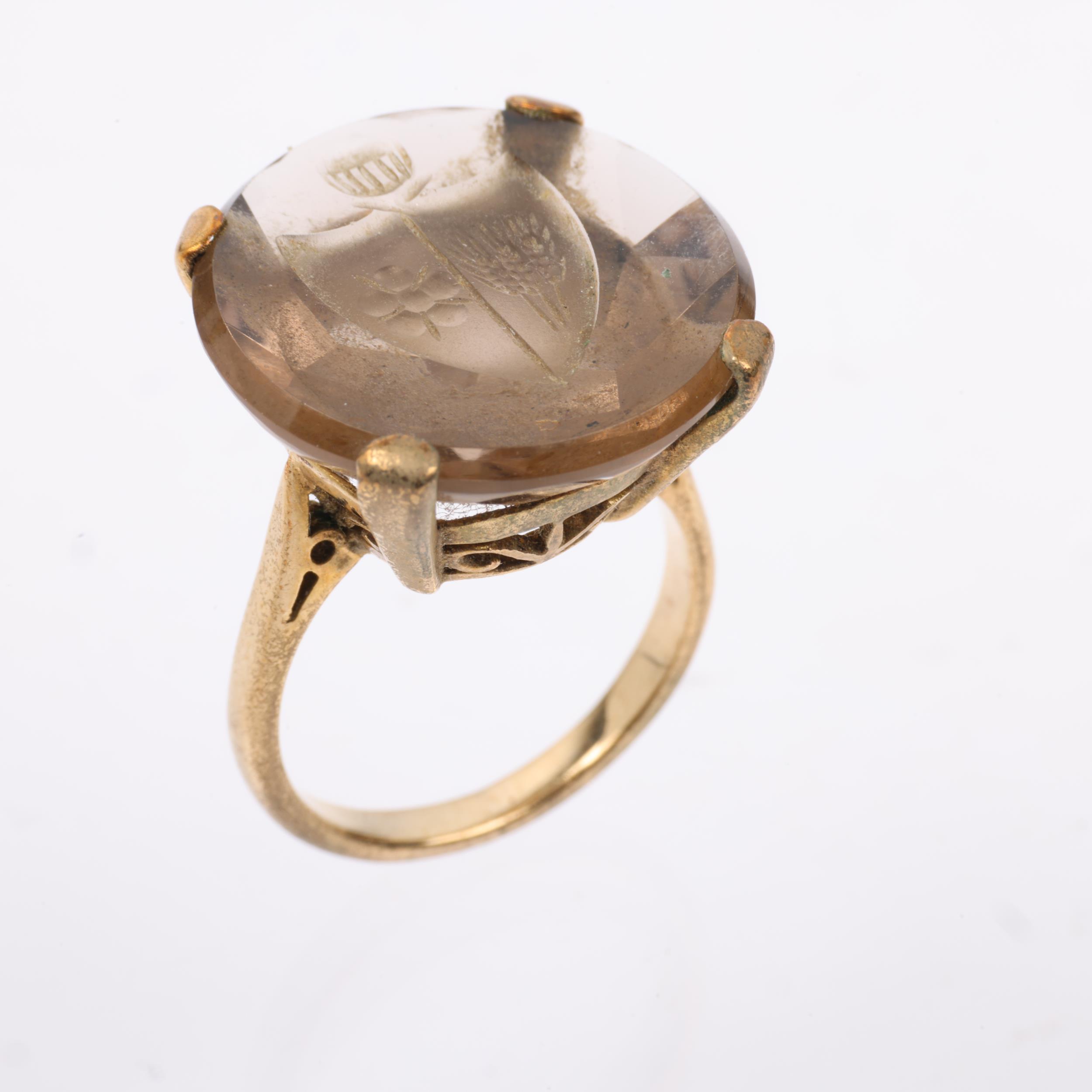 A late 20th century 9ct gold smoky quartz armorial seal ring, the round smoky quartz intaglio carved - Image 2 of 4