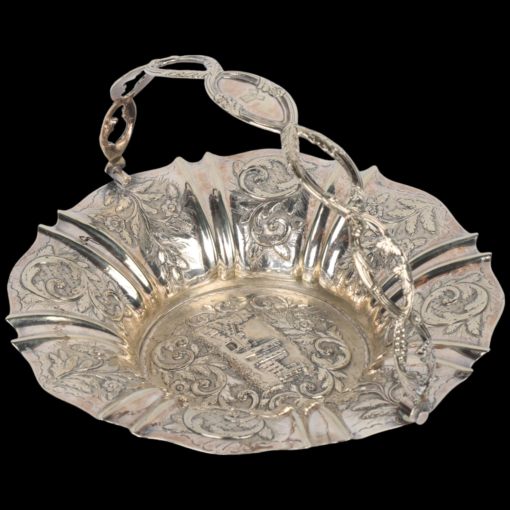 A Victorian unmarked silver 'Castle Top' swing handled cake basket, no maker, circa 1840, relief