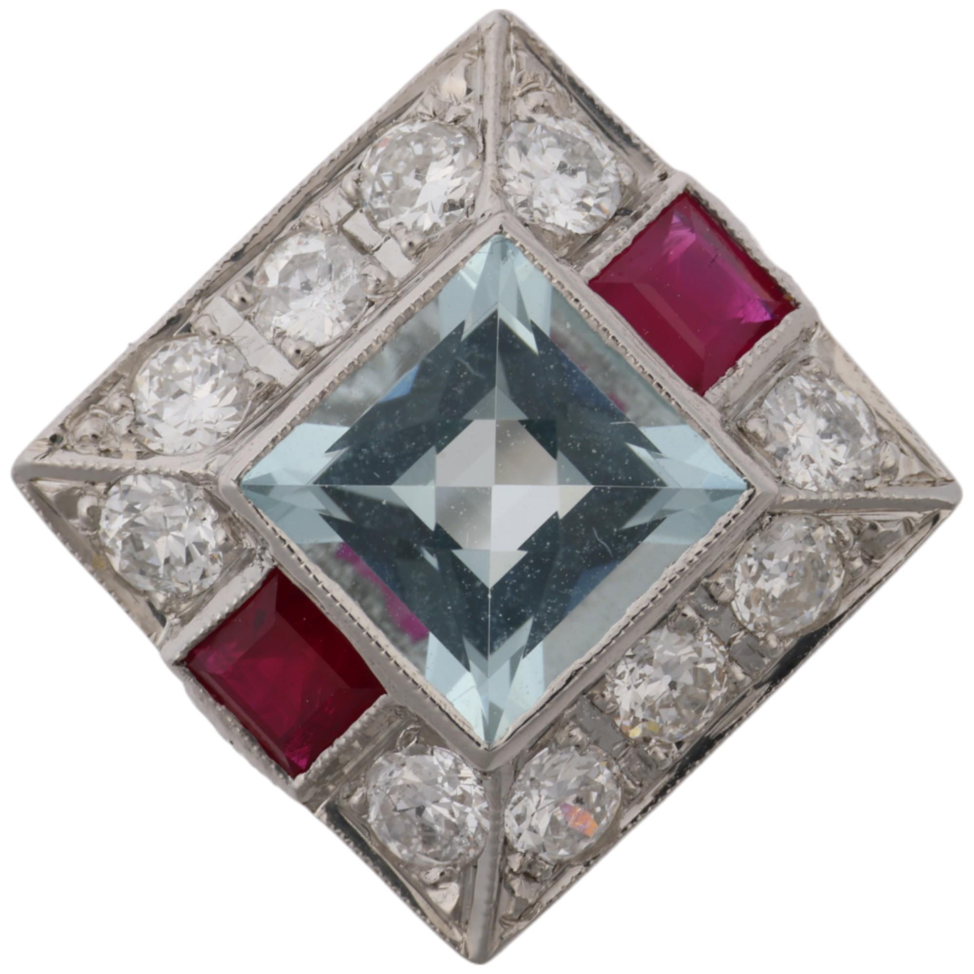 An Art Deco style platinum aquamarine ruby and diamond square panel ring, set with square-cut rubies