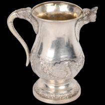 A good quality Indian silver cream jug, probably Bombay 1900, baluster form with cast lion spout,