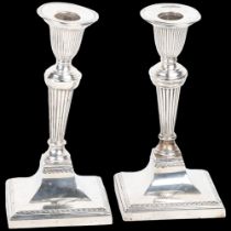 A pair of late Victorian silver table candlesticks, Richard Hodd & Son, London 1896, in the Sheritan