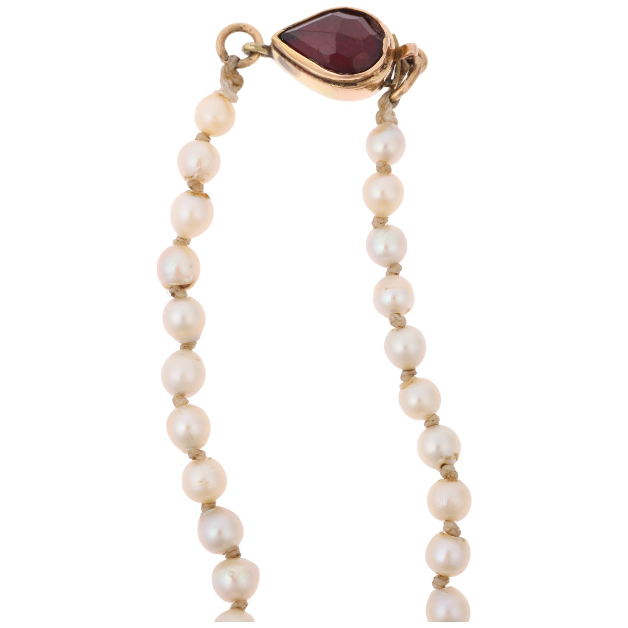 A Vintage single-strand graduated pearl bead necklace, unmarked gold garnet clasp, pearls measure